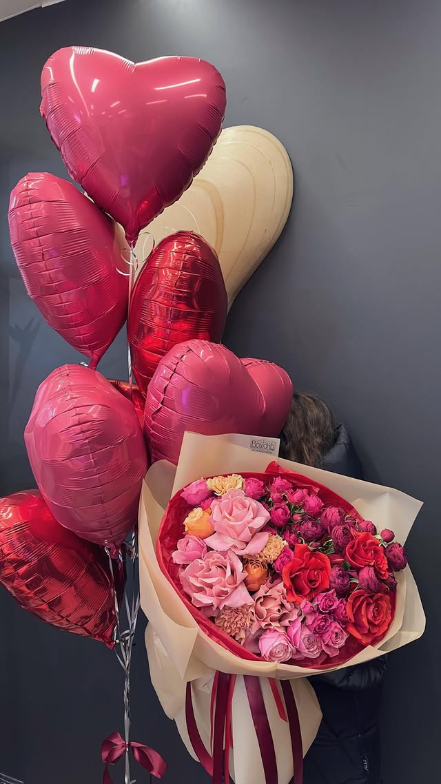 Rose and garden flowers bouquet with heart-shaped balloons
