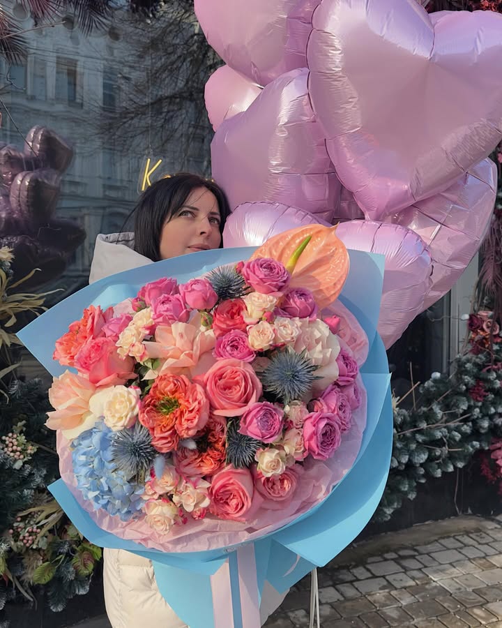 Bouquet of roses, anthuriums and hydrangea in delicate blue wrapping