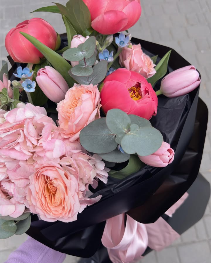 Bouquet with peony-like roses and tulips in pink-red tones