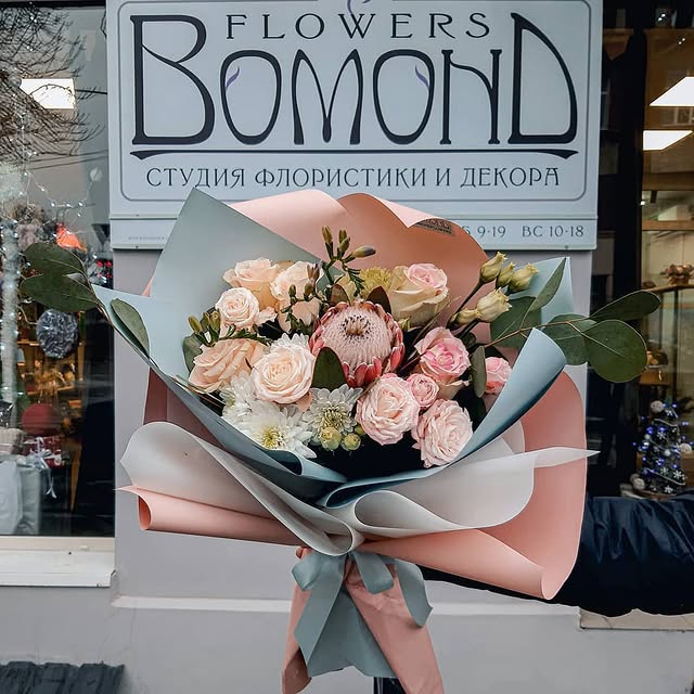 Bouquet of delicate roses with protea and eucalyptus