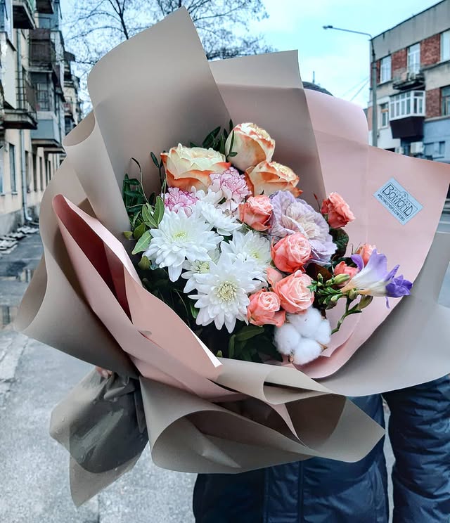 Bouquet of delicate pastel roses with chrysanthemums and cotton