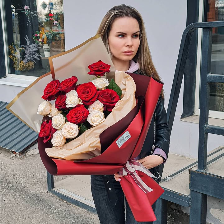 Bouquet of red and cream roses with elegant wrapping