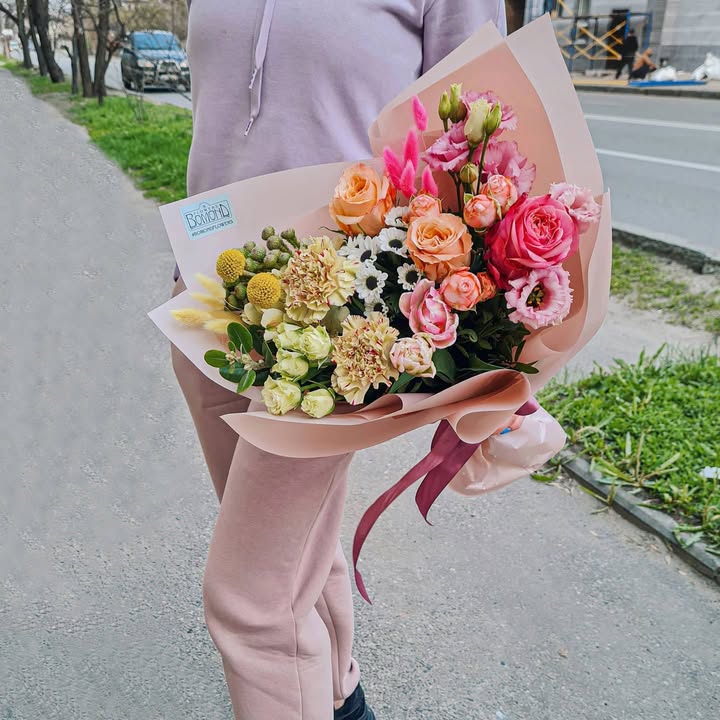 Mixed bouquet of pink and peach roses with eustoma and chrysanthemums