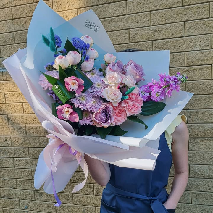 Bouquet of roses, peonies, and orchids in delicate lilac-pink tones