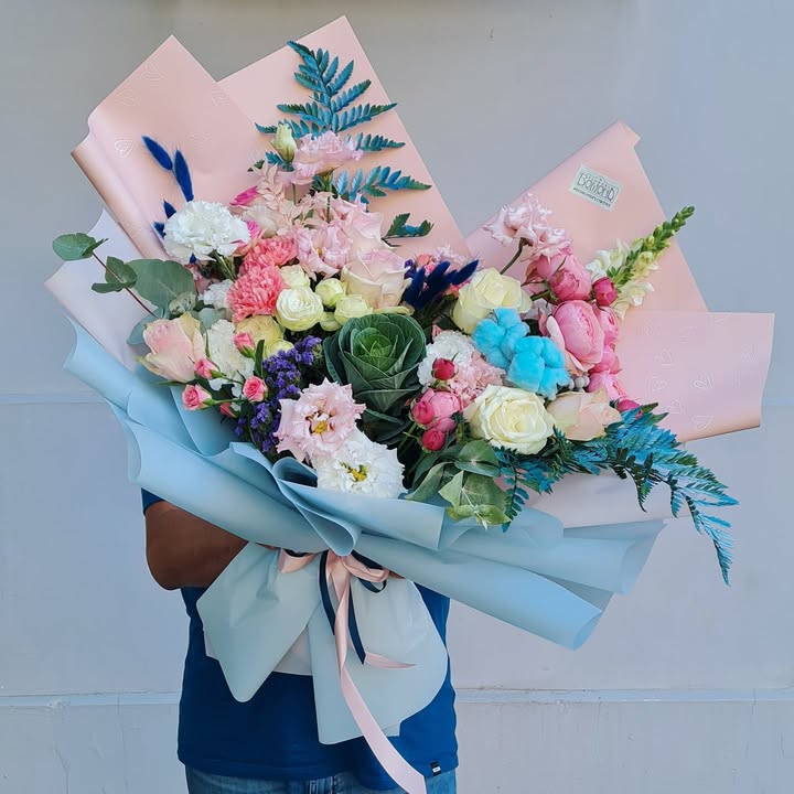 Creative flower bouquet with pink, white and blue accents