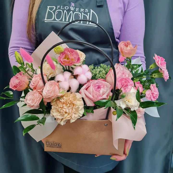 Tender floral arrangement in a bag with pink and cream flowers