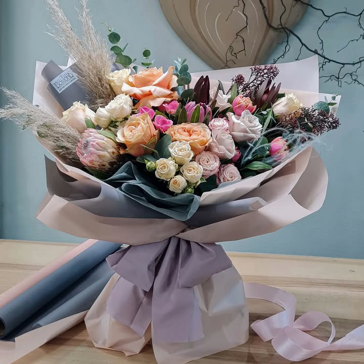 Bouquet with Soft Roses and Exotic Flowers in Pastel Tones
