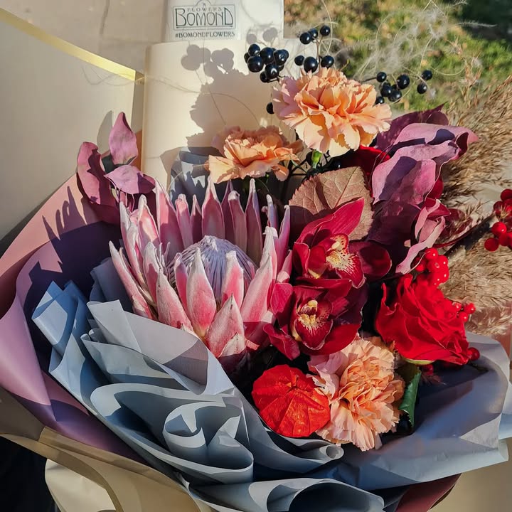 Bouquet with Protea and Orchids in Autumn Shades