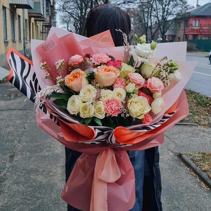 Large bouquet of roses and lisianthus in stylish wrapping