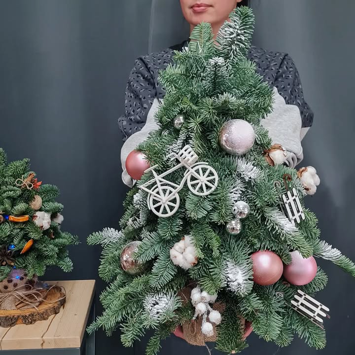 Christmas arrangement of natural fragrant pine with decorative balls and figures