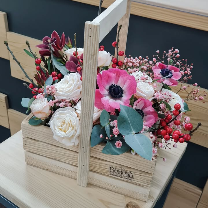 Floral arrangement with anemones in a wooden box
