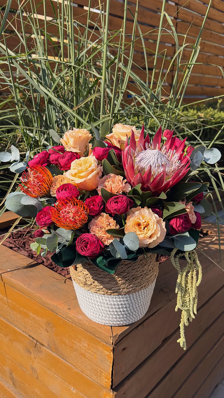 Mixed Flower Arrangement with Protea and Roses in Woven Basket