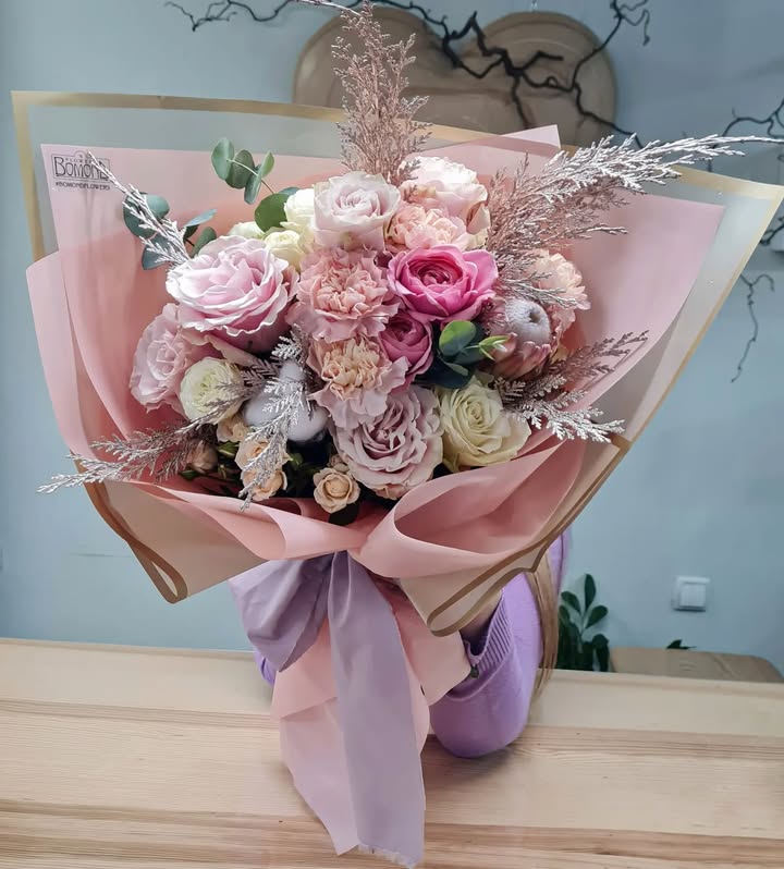 Romantic bouquet of roses and carnations in soft pastel tones