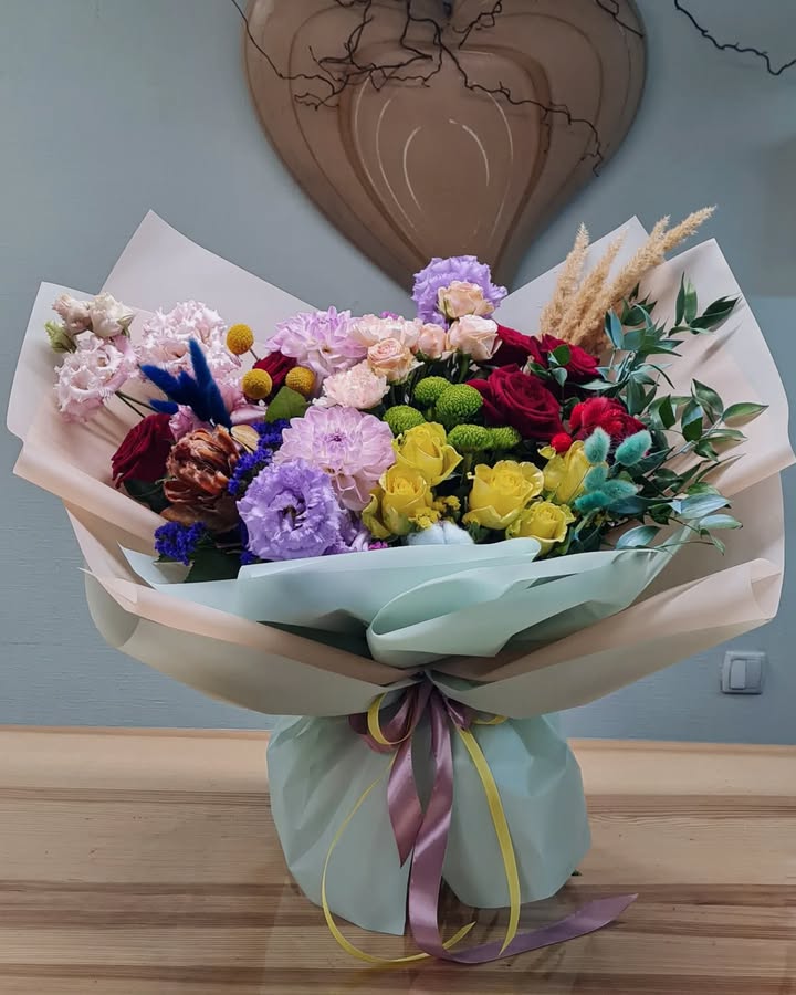Rainbow bouquet of roses and seasonal flowers