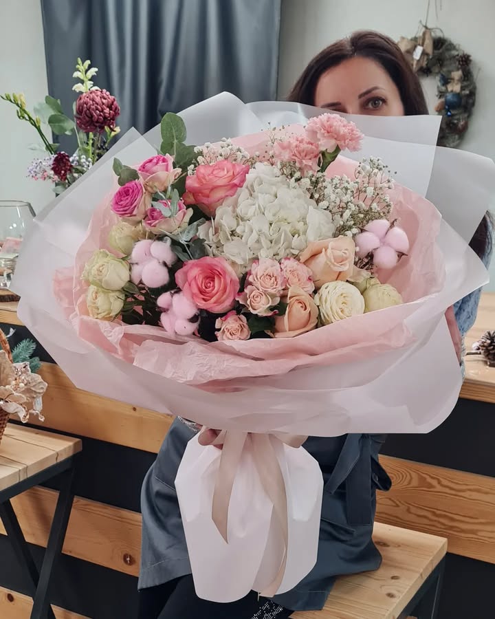 Bouquet of delicate roses, hydrangea, and cotton in soft pink tones