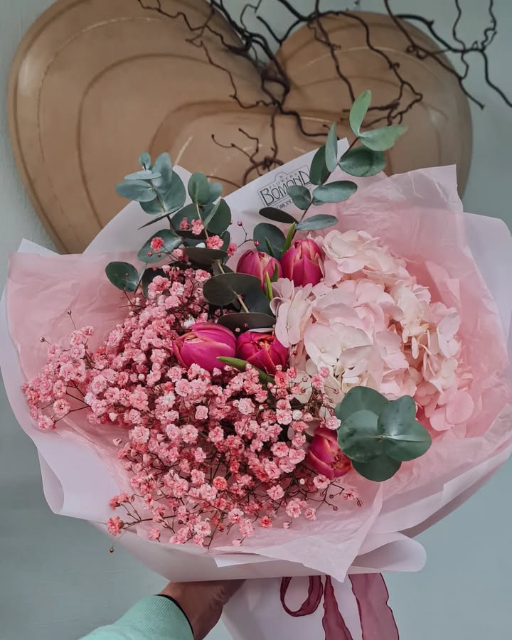 Bouquet of tulips, gypsophila, and hydrangea in soft pink hues