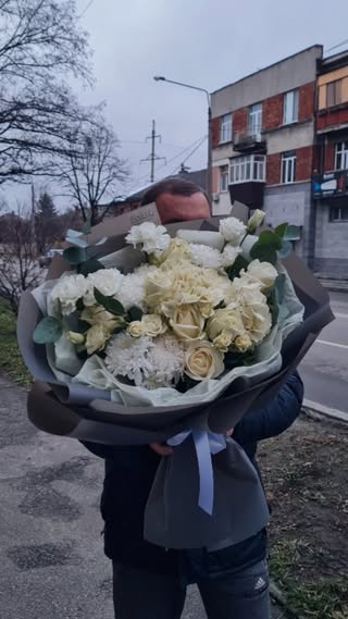 Bouquet of white roses and carnations in stylish wrapping
