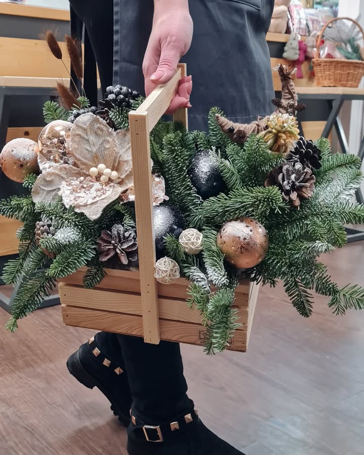 Christmas arrangement in wooden box with fir branches and decorations