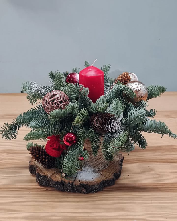 Christmas Arrangement with Red Candle and Decorations on Wooden Base