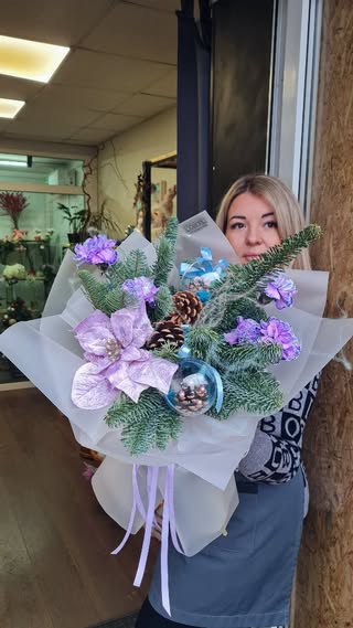New Year bouquet with fir branches and purple flowers