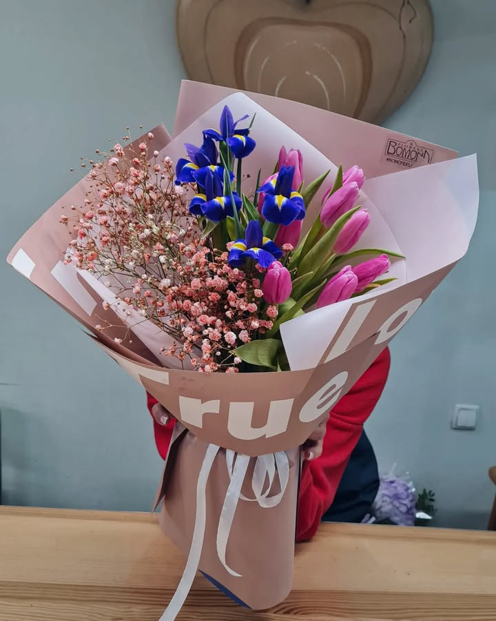 Spring bouquet with blue irises and pink tulips