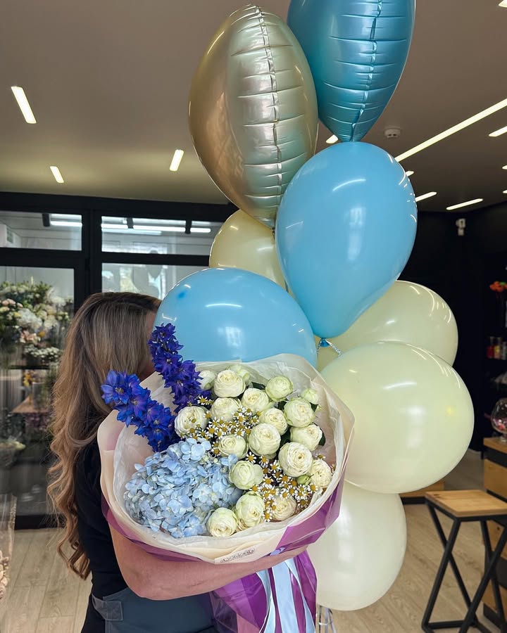 Bouquet of delicate white ranunculus and blue hydrangea with blue delphiniums