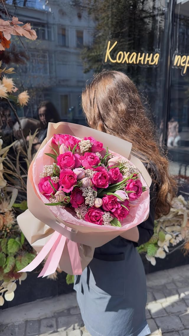Bright bouquet with raspberry roses and tulips