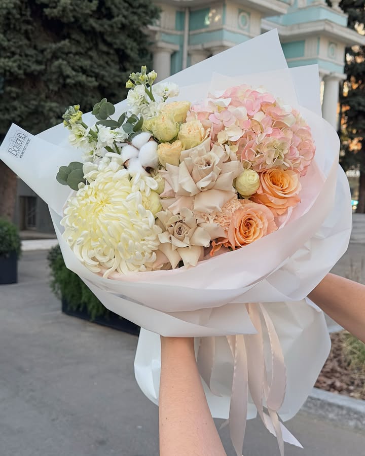 Bouquet of delicate cream-peach roses and hydrangeas with cotton