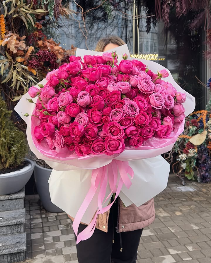 Large bouquet of bright peony-like roses in various sizes