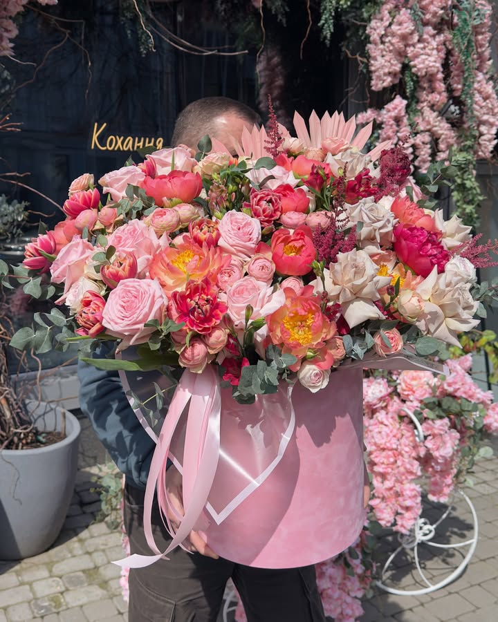 Large soft-bright floral arrangement in a pink box
