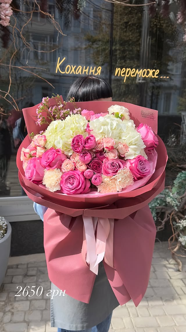 Large bouquet of roses and hydrangeas in pink wrapping