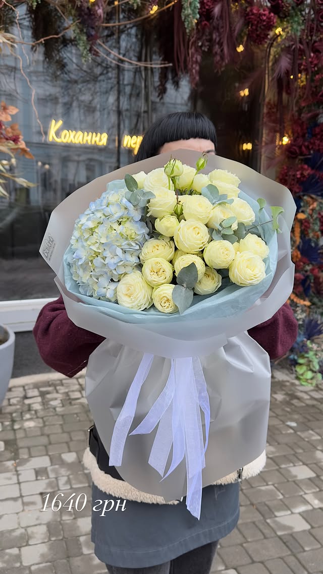 Bouquet of yellow ranunculus and blue hydrangea