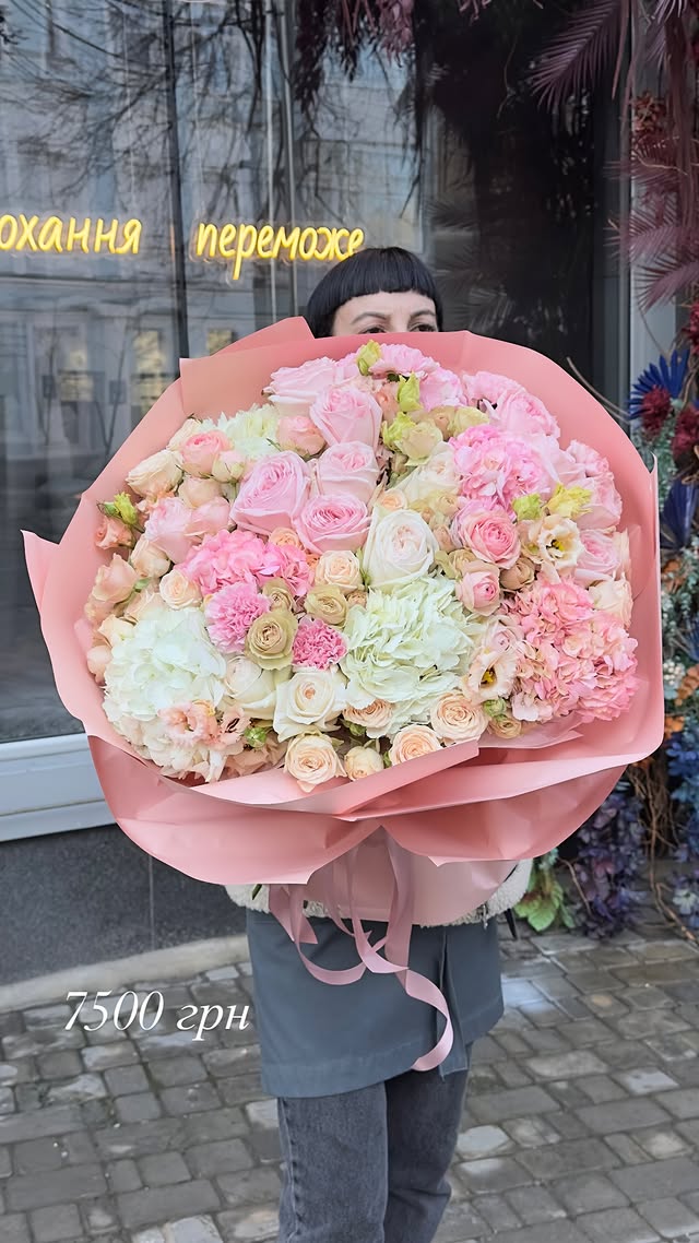 Large bouquet of delicate roses, hydrangeas, and garden flowers in pastel shades
