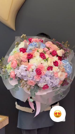 Large bouquet of hydrangeas and roses in soft pastel tones