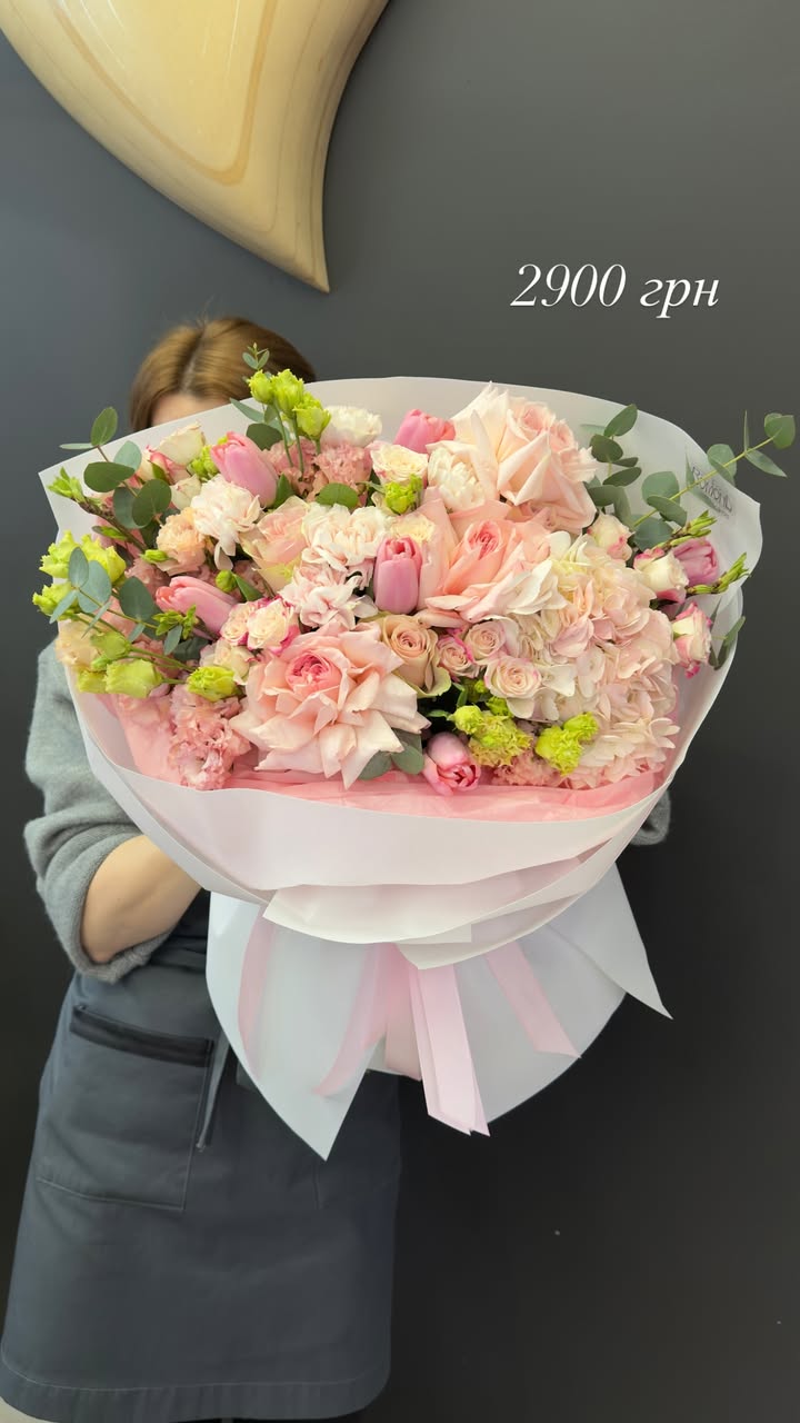 Large bouquet of pink and cream roses with tulips and greenery