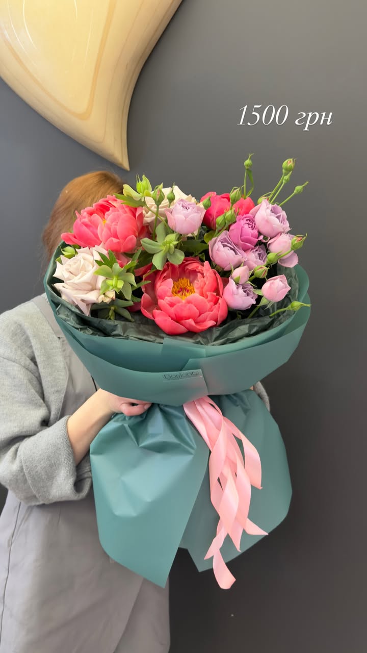Large bouquet with peonies and roses in green wrapping